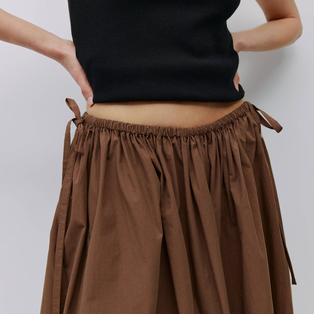 
                      
                        The Kiana Midi Skirt with Side Waist Ties
                      
                    