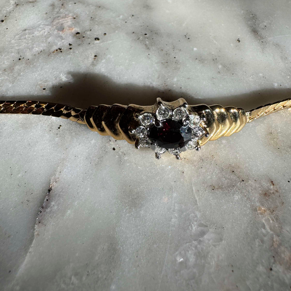 
                      
                        Vintage Gold-Tone Bracelet with Deep Red Centerpiece
                      
                    